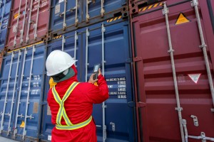 Foreman control loading Containers box from Cargo freight ship for import and export