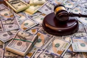 judge's gavel on pile of hundred dollar bills for bankruptcy court