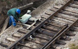 Railroad worker fixing railroad ties on railroad track