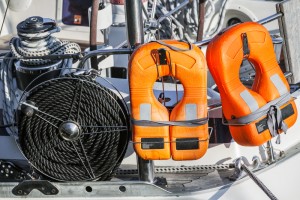 Orange lifebuoys and black rope, safety equipment of modern yacht