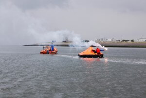 Lifeguards in training on small vessels using emergency safety boat flares