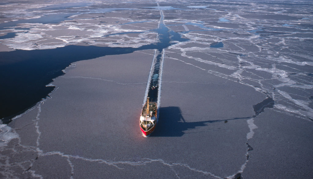 icebreaker ship cutting path through ice in the Arctic