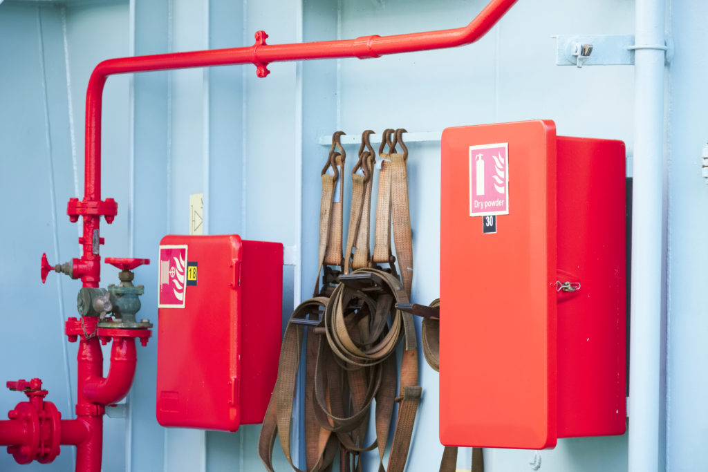 Dry powder fire extinguisher red cabinet on ferry ship UK