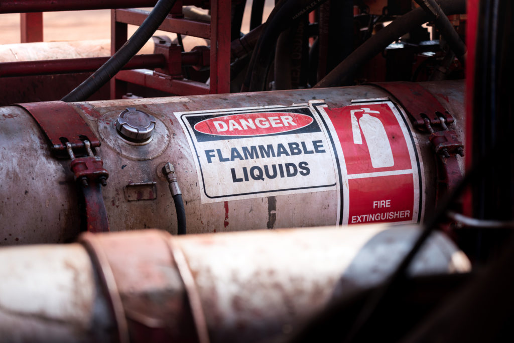 Flammable liquid storage tank with flammable warning label